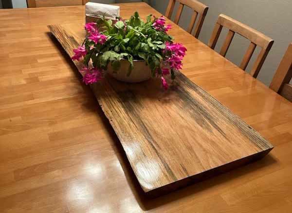 Four-foot pecan charcuterie board on a dining table