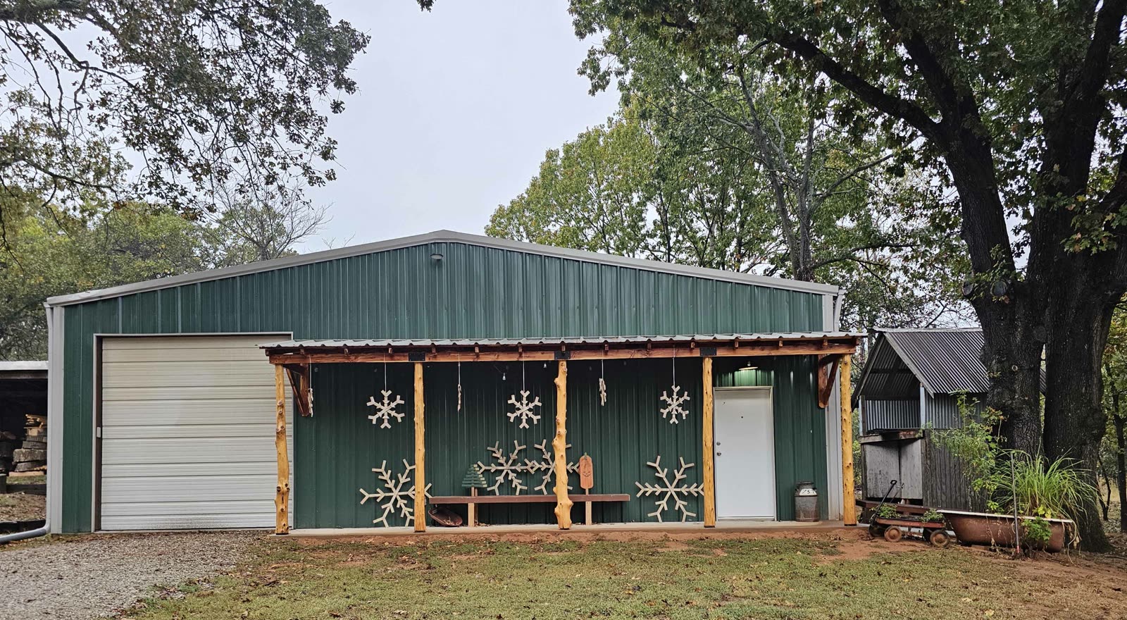 The green Jodi Wood Artisans shop building decorated with snowflakes